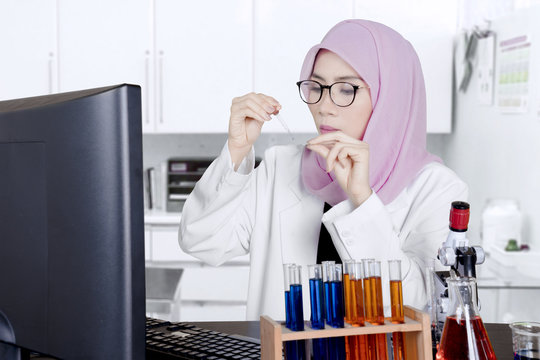 Female Muslim scientist doing research