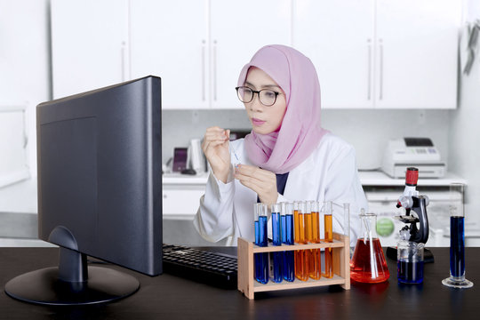 Female Asian researcher works in the lab