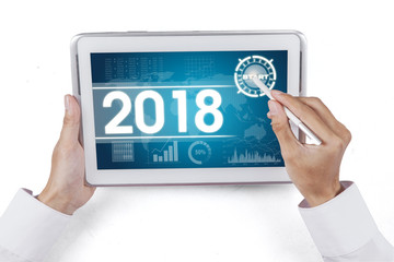 Businessman touching a start button on tablet