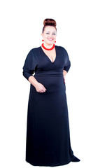 Obraz na płótnie Canvas Beautiful confident buxom woman in black evening dress in full, with red costume jewelry stands isolated in full growth on a white background