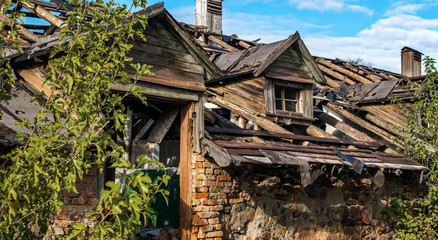 An big old abandoned ruined wooden building. Broken doorway and andattic. Ukraine