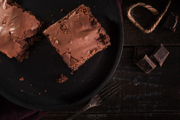 Brownie chocolate cake on dark moody background