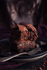 Brownie chocolate cake on dark moody background - 179464930