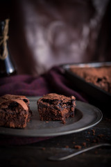 Brownie chocolate cake on dark moody background