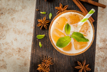 Traditional Indian drink is iced tea or chai masala, with ice cubes from chai, milk and mint...