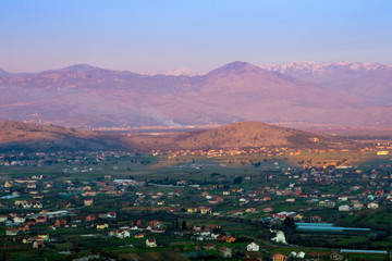 panorama of unreal sunrise, mountains and village