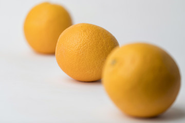 three oranges on a white background