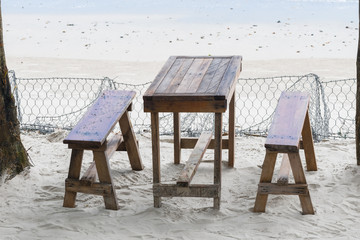 restaurant near the beach, table and benches on the sand near the sea