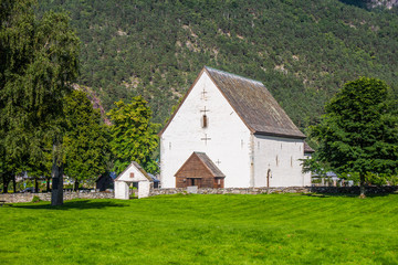 Fototapeta na wymiar Antique traditional norwegian church. Kinsarvik village. Visit Norway.