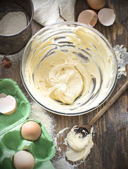 Making dough or cream and baking ingredients, eggs, flour / Recipe, cake, bowl, wooden spoon, 