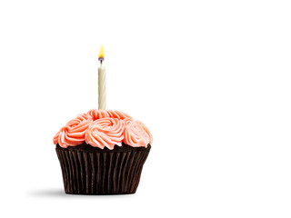 Pink cupcake with candle flame isolated on white