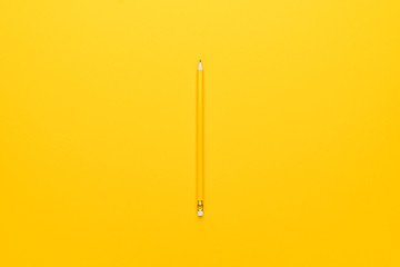 yellow pencil with eraser on paper background