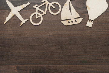 different means of transport made of wood on the table. traveling concept with copy space