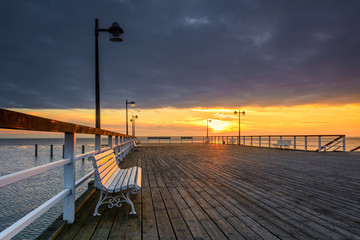 Wooden pier in Jastarnia village on Hel Peninsula at sunset time. Poland.