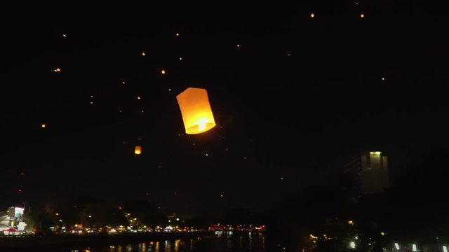 floating sky lanterns at ping river in Chiang Mai ,Thailand