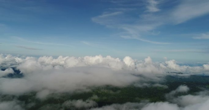 Aerial View. Flying over the beautiful mountain in clouds.