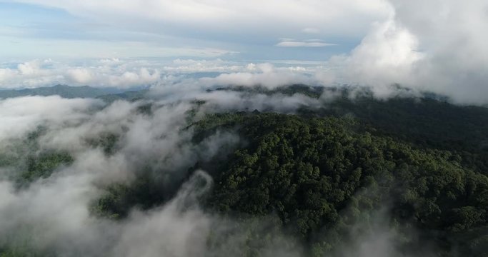 Aerial View. Flying over the beautiful mountain in clouds.