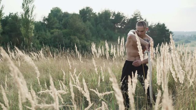 Modern cossack workouts with swords in the fields 4K