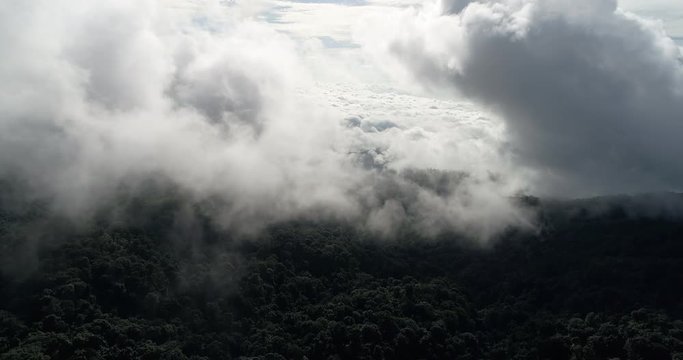 Aerial View. Flying over the beautiful mountain in clouds.