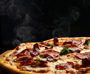 Hot big pepperoni pizza tasty pizza composition with melting cheese bacon tomatoes ham paprika...