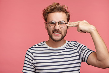Annoyed stressed young handsome man being thick and tired of quarrels with wife, has bad...
