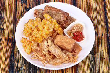 Deep fried dessert of sweet corn,tofu ,taro and  spring roll served with spicy sweet sauce.
