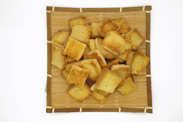 Toast bread on the bamboo fabricate.Isolated on white background.