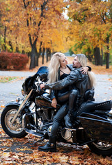 Naklejka na ściany i meble Couple on a bike in a leather jackets 