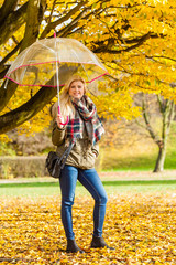 Woman walking in park with umbrella