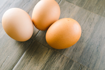 Brown eggs on wood background