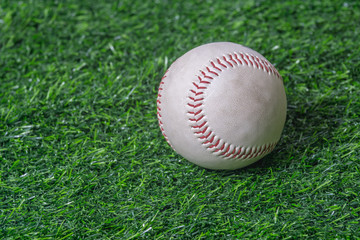 Close up baseball on the green lawn