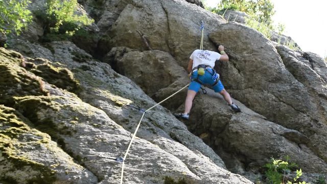 a younger man climbs to the rock, rock climbing equipment, Free climbing	