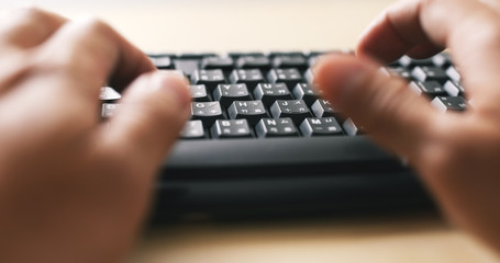 Man hands typing on a computer keyboard