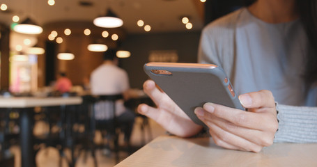 Woman use of smart phone in coffee shop