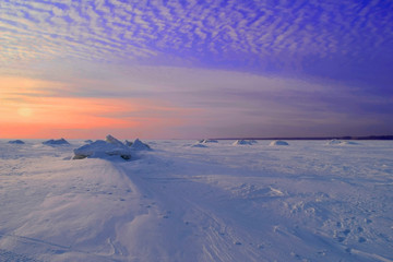 Winter sunset over frozen lake in Siberia.