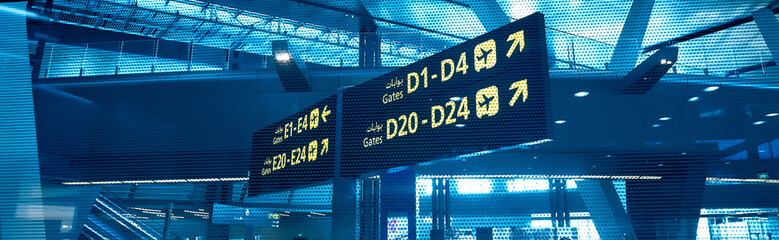 Gates D and E. Sign in airport. Interior of the airport..