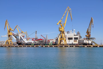 port cranes in the harbour of cadiz, spain