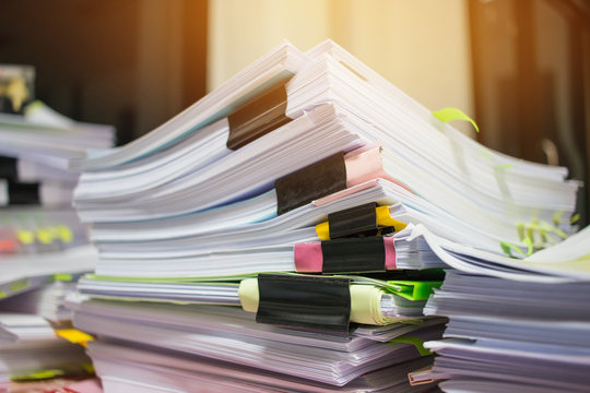 Paper stack, Pile of unfinished documents on office desk related to business functions. Stack of business papers for Annual Report files, Document is written,drawn,presented. Business offices concept.