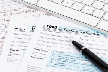 Tax form with keyboard, and pen