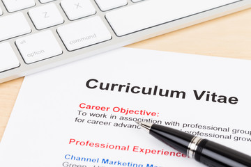 Curriculum vitae and keyboard with pen, document is mock-up