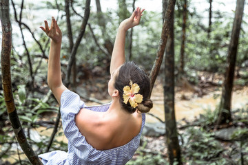 girl in a dress in the rain forest