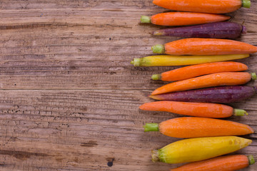 Rainbow carrots on a rustic wooden background. Healthy eating concept.Copy space. 