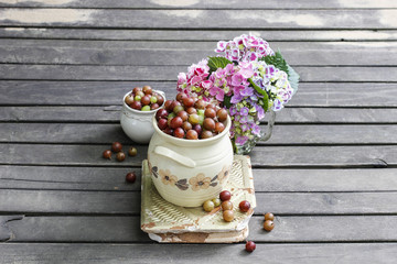 Jug of gooseberry on wooden table
