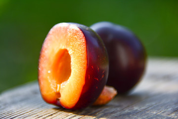 Plums on a wooden table in the garden
