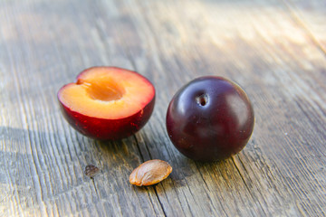 Plums on a wooden table in the garden