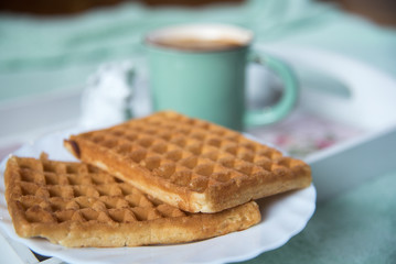 Waffles, coffee and milk in cow shaped container