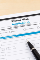 Visa application form with pen