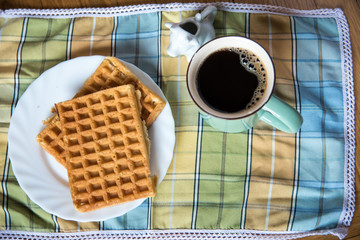 Waffles, coffee and milk in cow shaped container