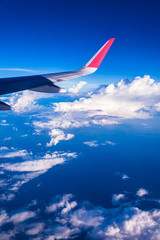 Fototapeta premium Clouds and sky as seen through window of an aircraft