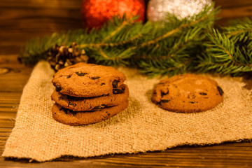 Chocolate chip cookies and christmas decorations on a wooden table